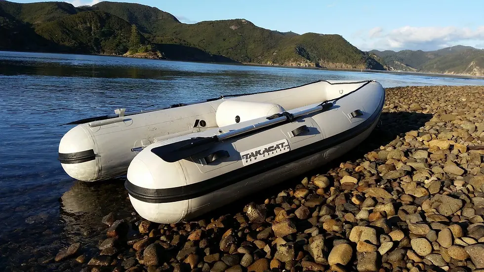 Thumbnail: T340S Inflatable Boat rear view on rocky beach