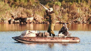 Camo Hunting in inflatable boat.jpg