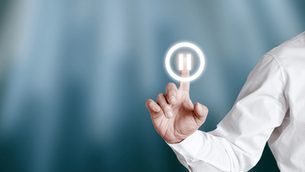 Business leader pressing a digital pause button, symbolizing awareness and choice over emotional reactivity in leadership.