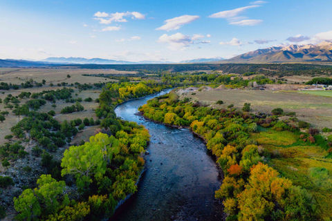 Drone aerial photography of Colorado river valley with autumn foliage and mountain range – FAA certified drone pilot Alex Miller