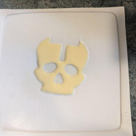 Melted white chocolate poured into front skull moulds.
