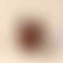 Brown leather satchel bag on a white surface with long strap.