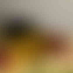 Black leather bag spilling yellow flowers on a table setting. Feather Touch Impex Pvt. Ltd.