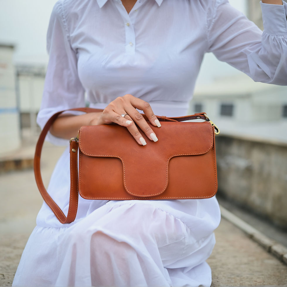 Woman holding the brown leather bag, Cross Body - FT-CB-505 outdoor setting.
