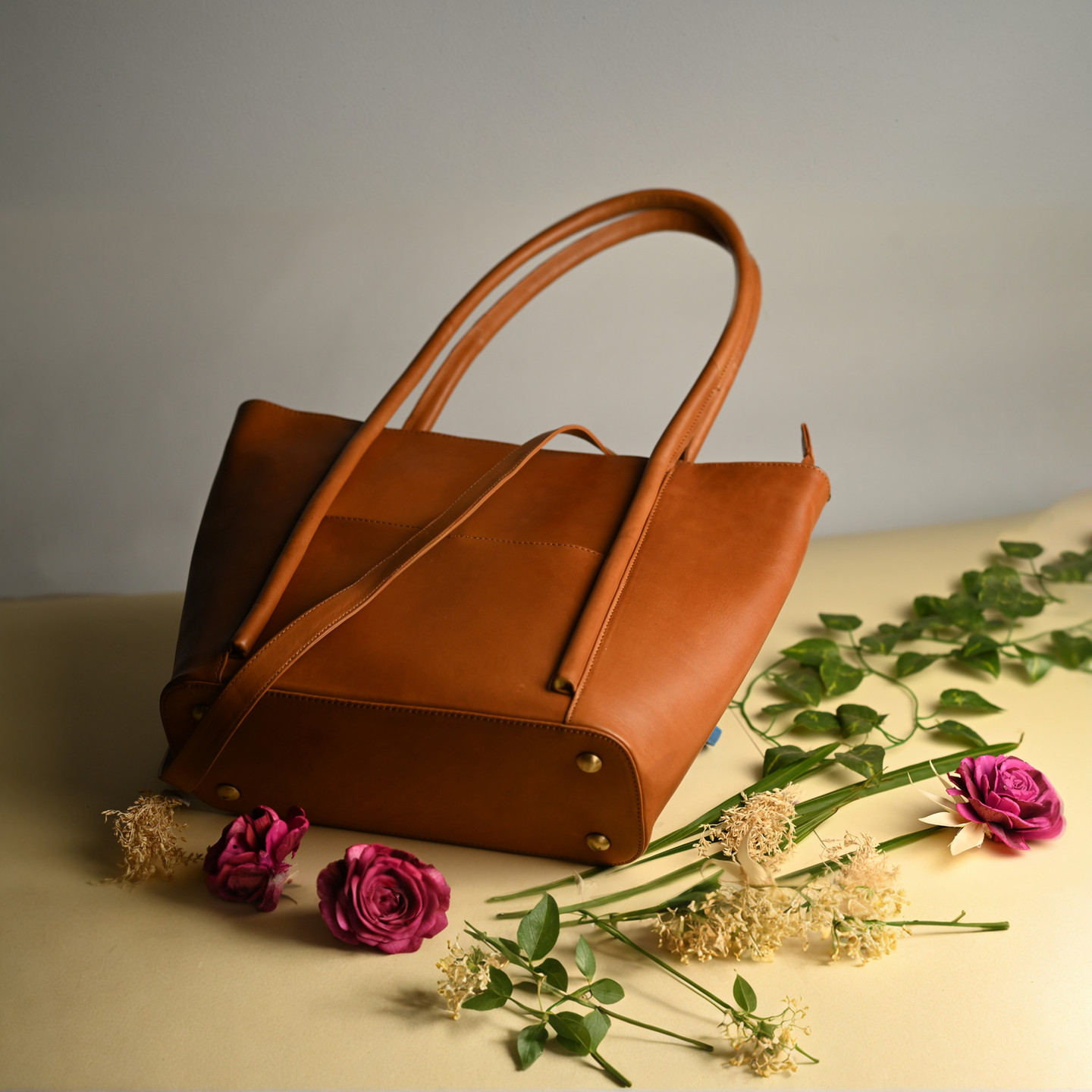 Brown leather tote bag with flowers and greenery, Feather Touch Impex Pvt. Ltd.