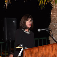 A woman in black dress speaking.