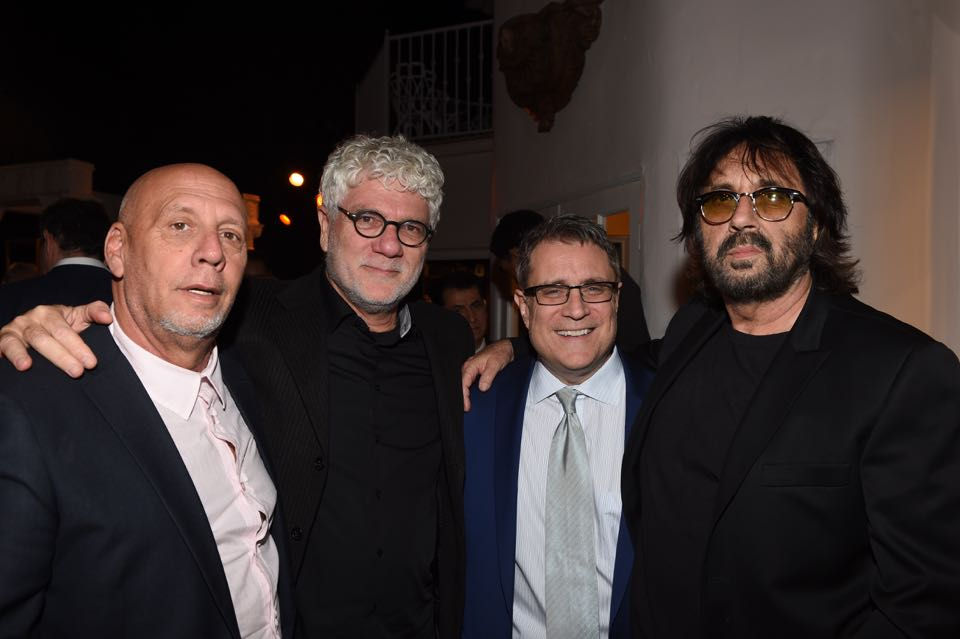 Shuki Levy with three other people smiling for a picture.