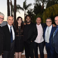 Shuki Levy and Tori Avey Levy with five other people smiling for a picture.