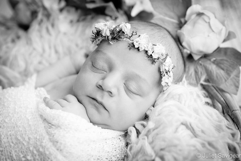 Newborn baby with flowers
