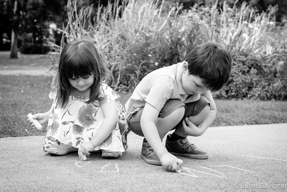 Children playing with chalks in the park