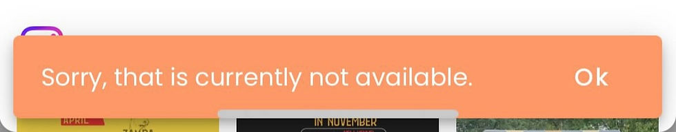 Orange banner with the message "Sorry, that is currently not available." followed by "Ok" on the right. Background shows partial images.