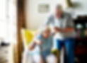 Elderly couple, woman using cane, assisted by man.