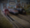 three n-scale engines in a row in front of a background of various train images.