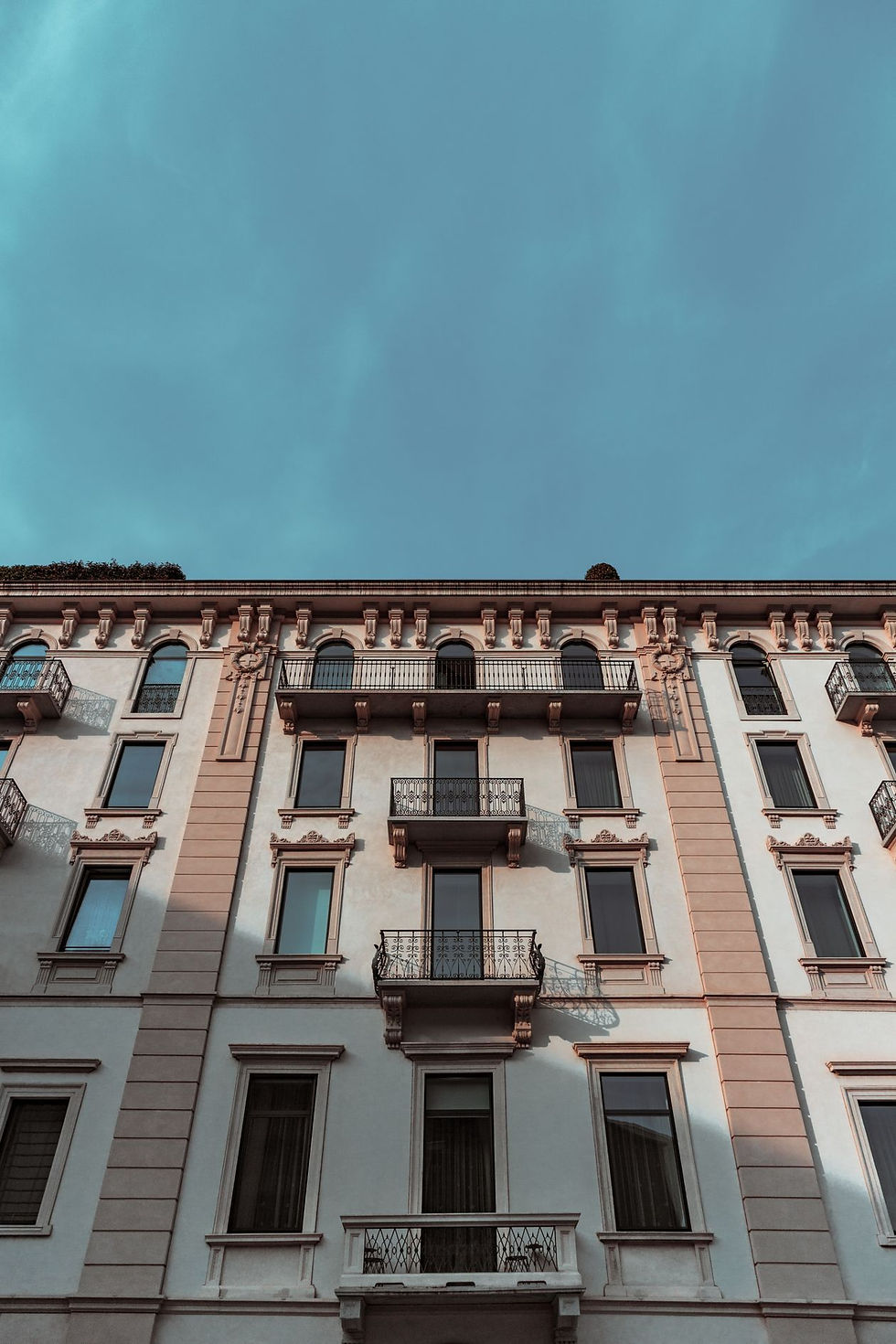 Fassade eines älteren Wohnhauses mit Balkonen als Sinnbild für eine kleine Eigentümergemeinschaft in Selbstverwaltung