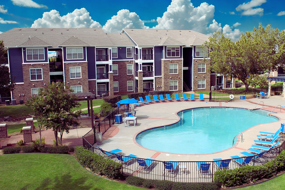 Overhead view of an apartment community with pool in the foreground.