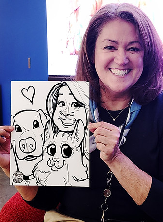 A woman holding up a fast 1-minute Quick Caricature of herself and her dog and cat drawn from a photo at an event in Overland Park, KS by a Caricatures by Marietta Pet Caricature artist.