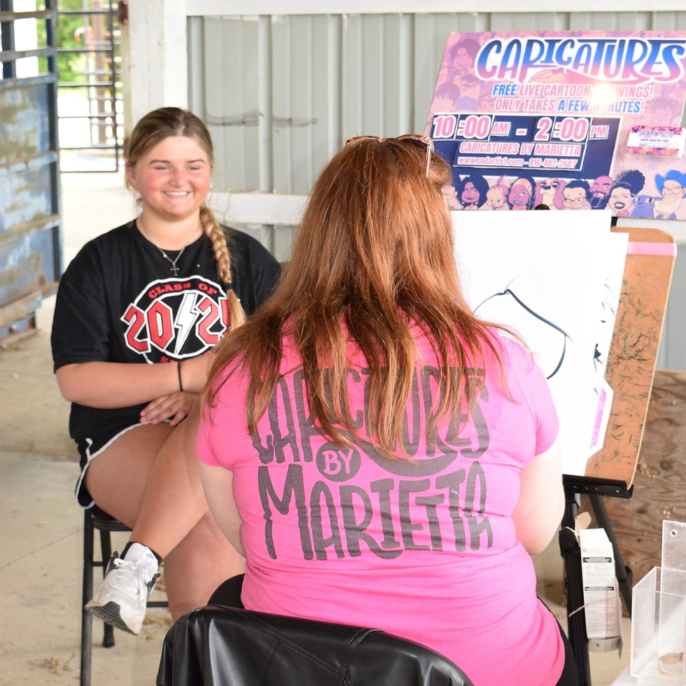 A Caricatures by Marietta caricature artist drawing caricatures for a senior day at a high school ea