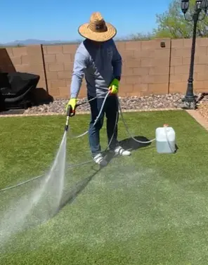 xjet sprayer applying cleaning solution to artificial turf