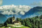 Kirche St. Cassian with its cemetery & the snow covered peaks beyond - from the window of the Bernina Express, Sils im Domleschg, Switzerland