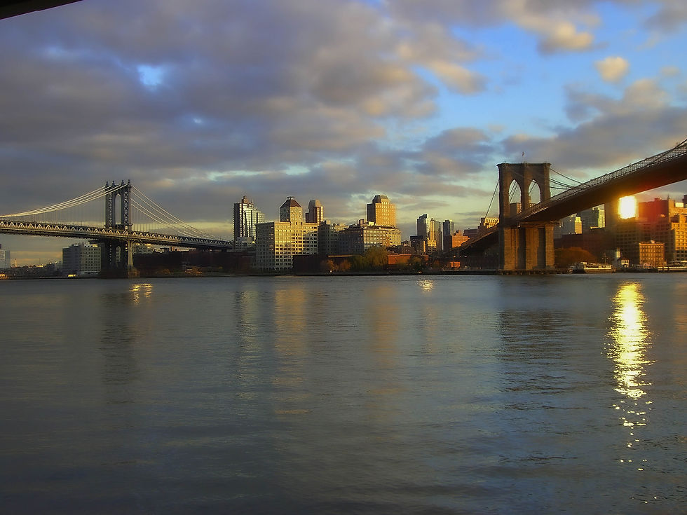 Sun glaring on Brooklyn as it is about to set & a glassy East River, New York, NY