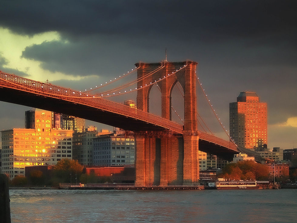 Brooklyn Bridge in the red from the setting sunlight, New York, NY