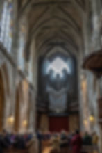 Église Saint Merri - The silhouettes of 3 large sinister figures look down on a service, Paris, France