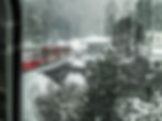 The train rounding a curve in a snow storm - from the window of the Bernina Express #5, Pontresina, Switzerland