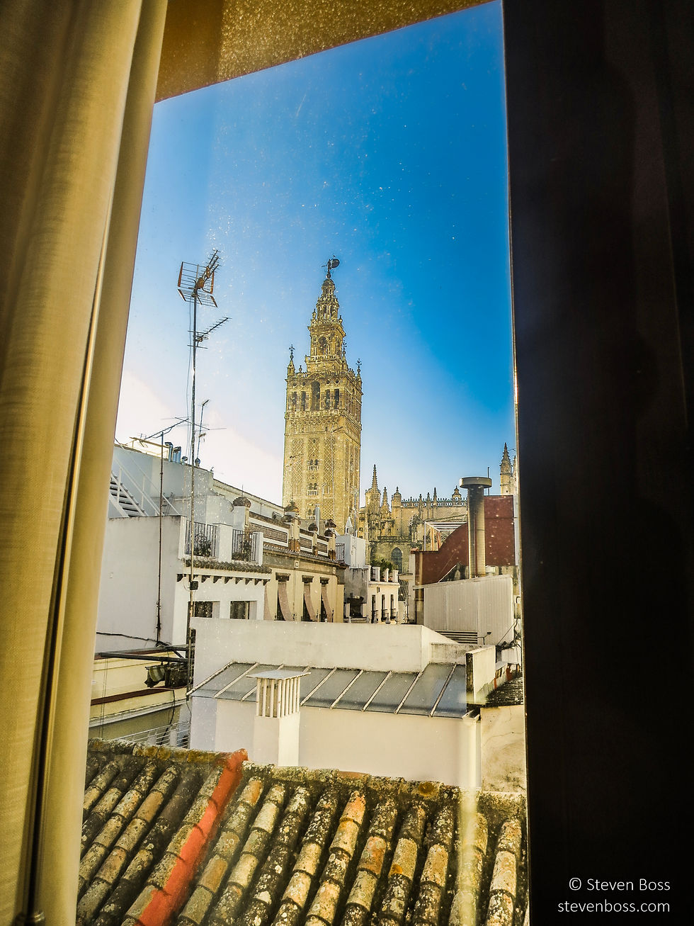 Through the window: view of La Giralda (bell tower formerly a minaret) #1, Seville, Spain