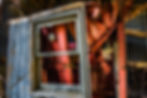 Light fixture on a red door through a window, New Jersey