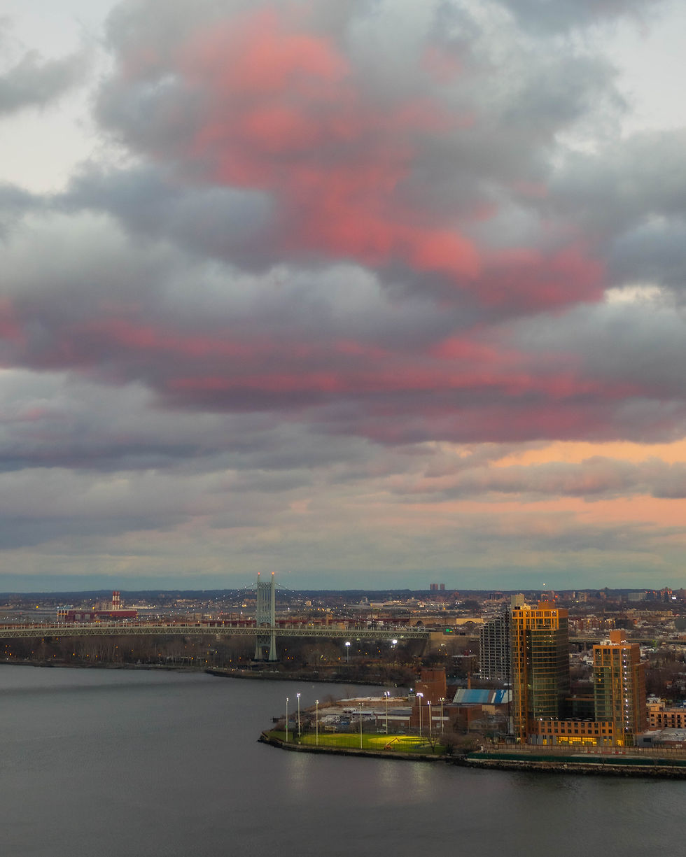 Setting sunlight on clouds over the Triborough Bridge, New York, NY