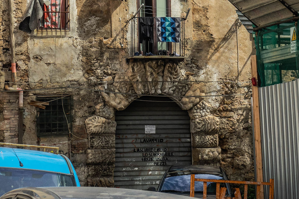 A gritty garage with an elaborate archway, Palermo, Sicily