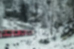 The train rounding a curve in a snow storm - from the window of the Bernina Express #4, Poschiavo, Switzerland