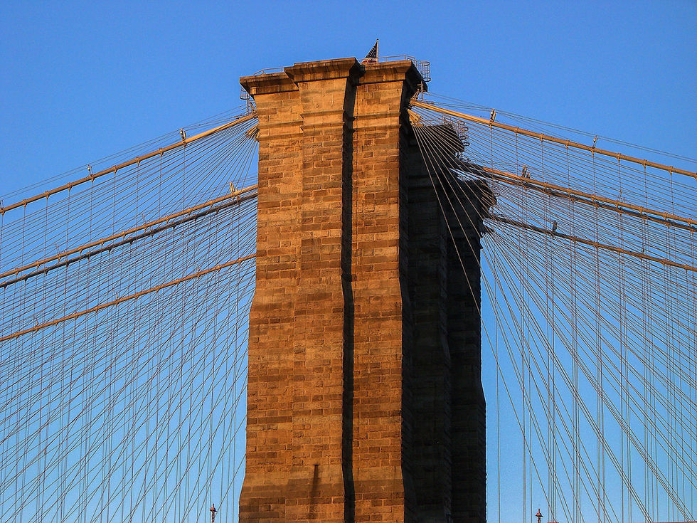 Brooklyn Bridge tower in early morning orange light, New York, NY