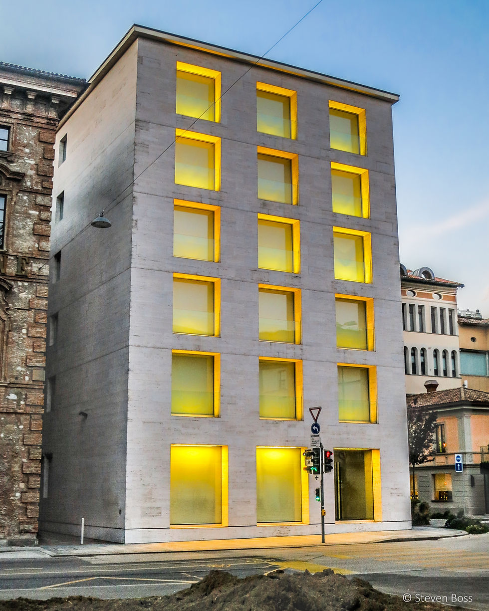 Rectangular building with yellow-lit windows, Lugano, Switzerland