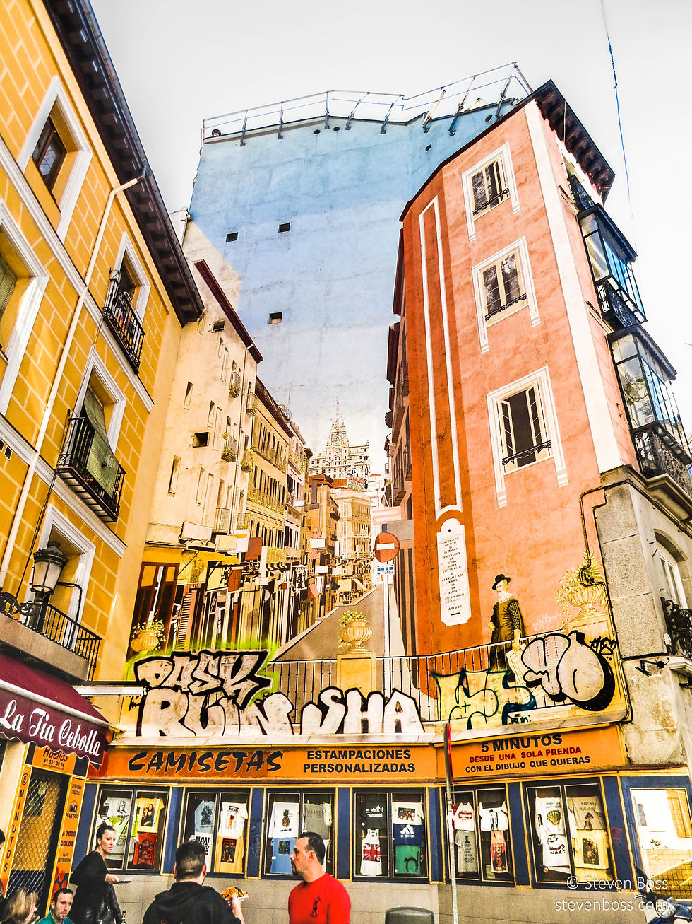 Al fresco dining at Taberna La Tía Cebolla under a mural by Ángel Aragonés, Madrid, Spain