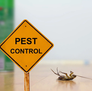 A yellow pest control warning sign, serving as the featured image for the Top 5 Pest Problems Wichita and Derby Homeowners Miss.