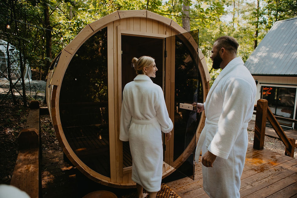 Couple in robes stepping into the private barrel sauna at The Wild Haven in Hochatown, Oklahoma