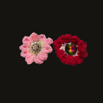 Pink and red crochet flowers with clear and amber colored rhinestones