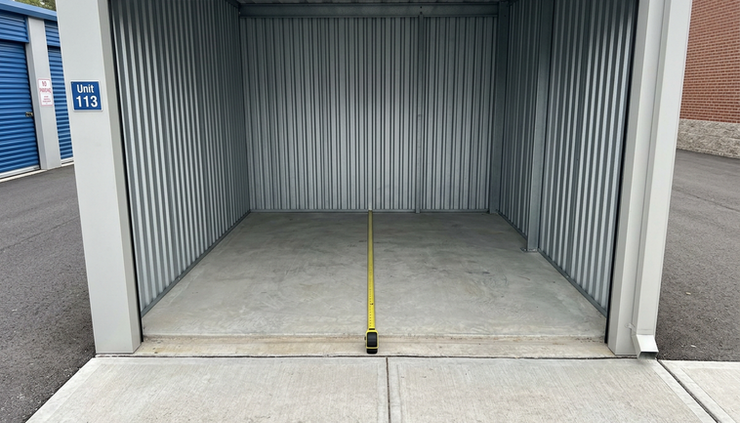 Close-up view of a vacant 10x10 storage unit with a clean concrete floor and open roll-up door.