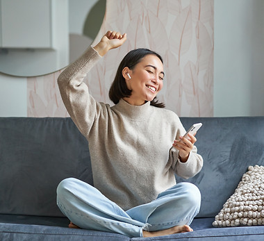 portrait-carefree-asian-woman-singing-listening-music-from-smartphone-app-using-wireless-h