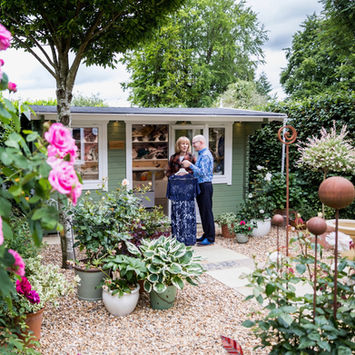 Customer arriving at the studio door through a colourful garden full of roses.