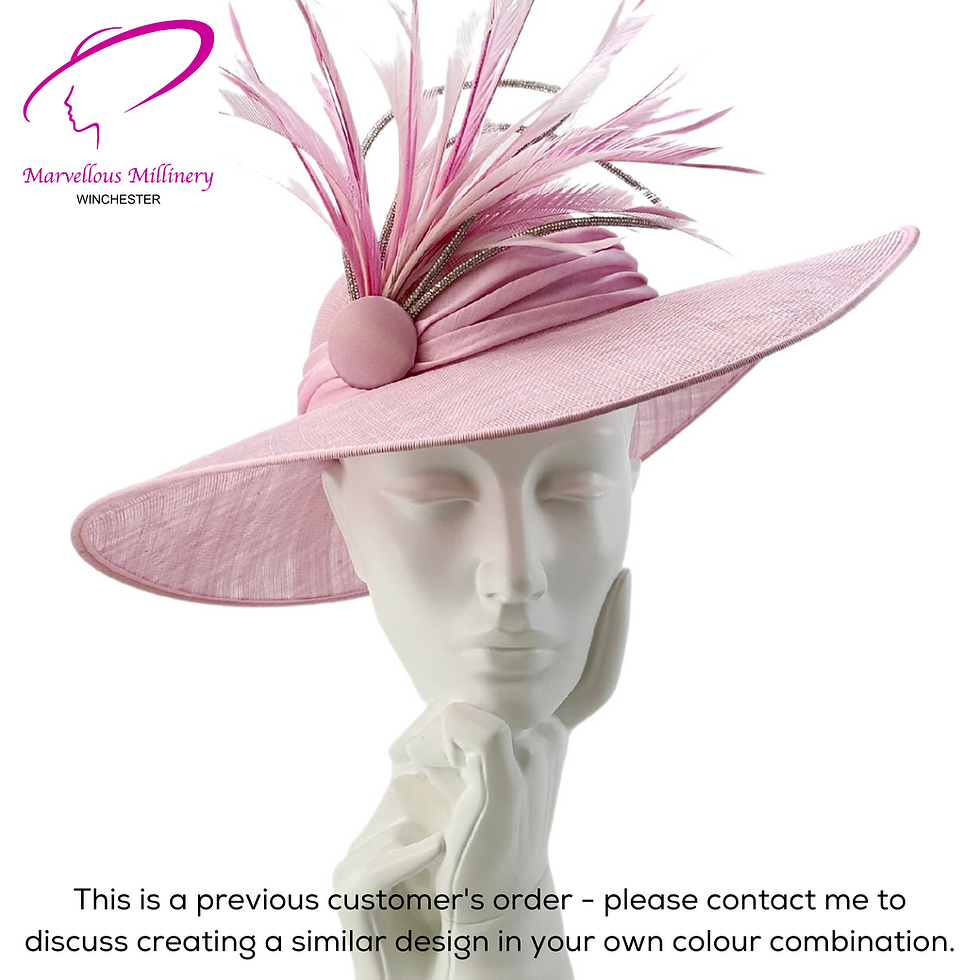 Bespoke wide-brimmed ladies hat in blush pink sinamay on a mannequin, featuring a dramatic spray of pink ostrich feathers with crystal cord trim — a previous customer order by Marvellous Millinery, Winchester.