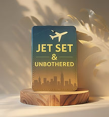 “Luggage tag featuring a minimalist skyline silhouette of a city at dusk with the phrase ‘Jet Set & Unbothered’ in bold white letters. A small plane icon soars above the text.”
