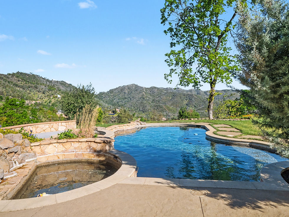 Outdoor swimming pool and spa with mountain views at a residential property in Shasta County.