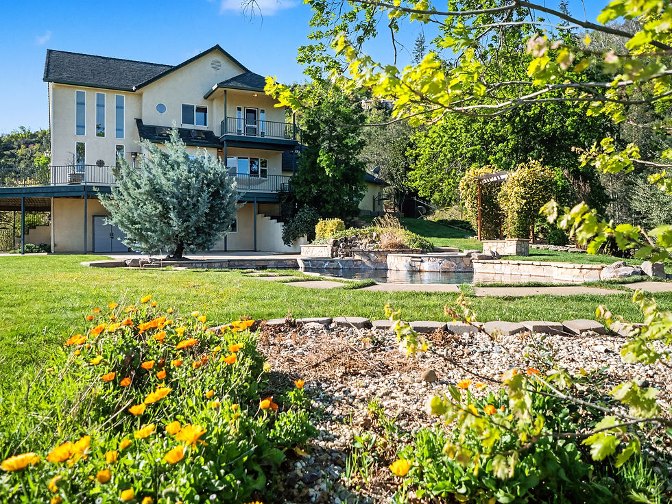 Exterior of a large multi-story home with landscaped grounds in Shasta County, California.
