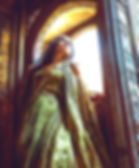 Woman in detailed green gown looks upwards beside ornate doorway. Sunlight streams in, casting a warm glow, creating an ethereal mood.