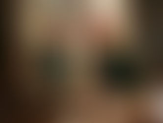 Rooster in a green velvet suit with gold embroidery looks at its reflection in an ornate mirror. Elegant room setting, regal mood.