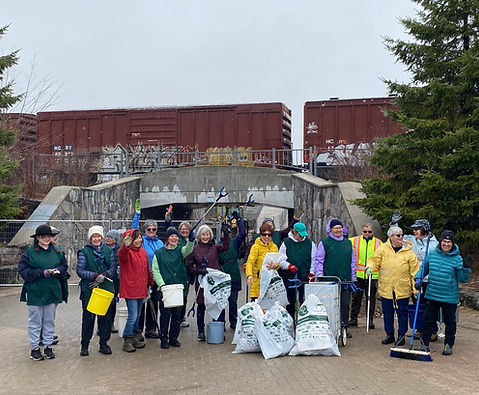 group gathered with litter pickup bags