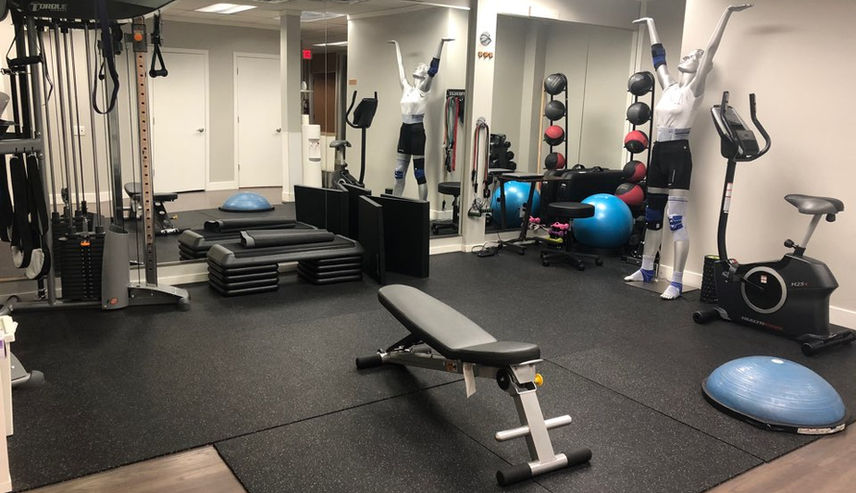 Modern home gym with workout bench and exercise bikes