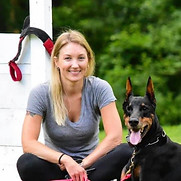 Woman smiling with Doberman